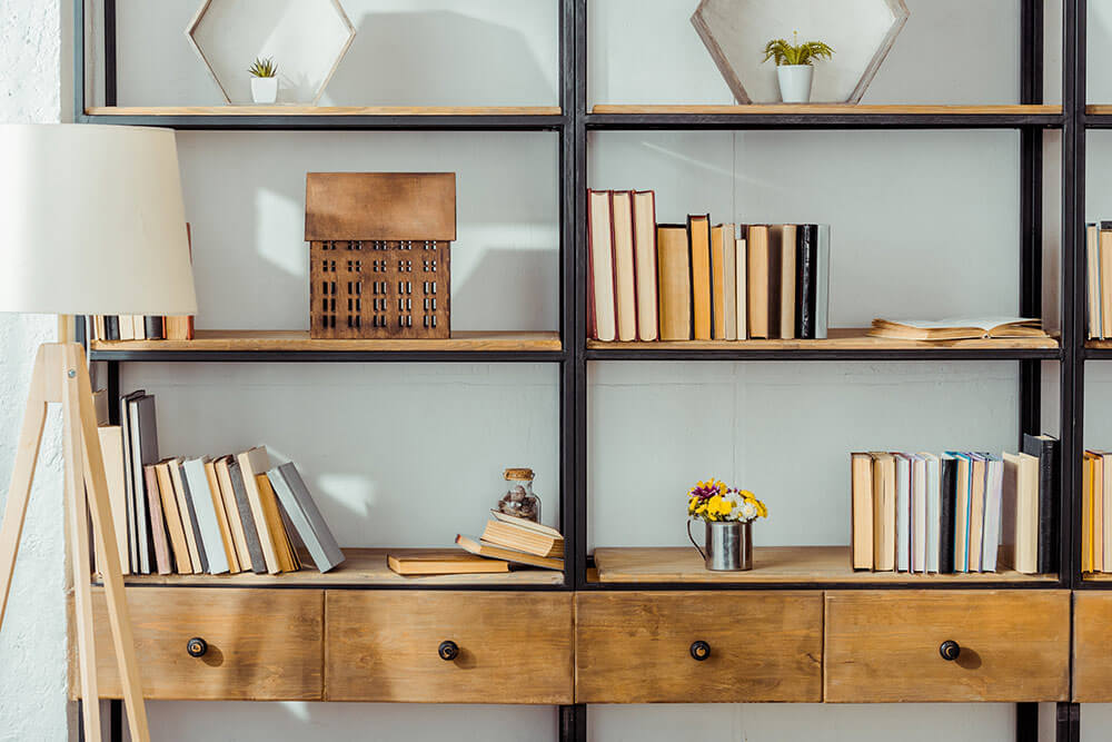 Vertical bookshelf with open storage in loft style apartment