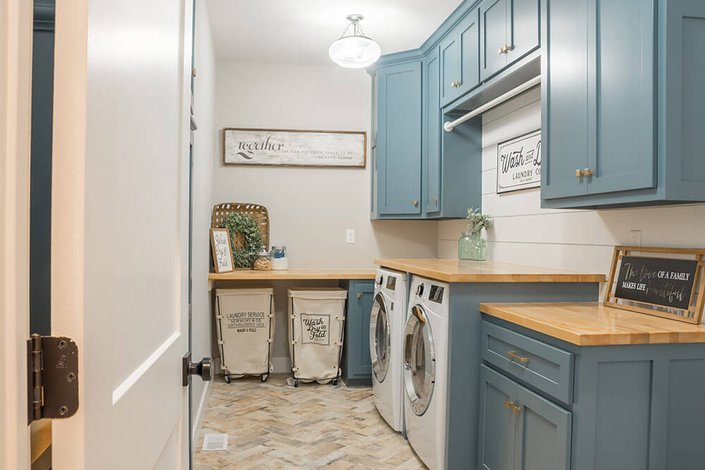 Cute laundry space, well organized with cabinets