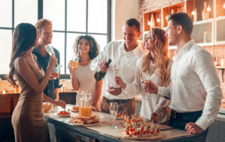 A group of friends talk and hang out at a holiday party