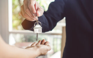 A man handing over the keys to an apartment