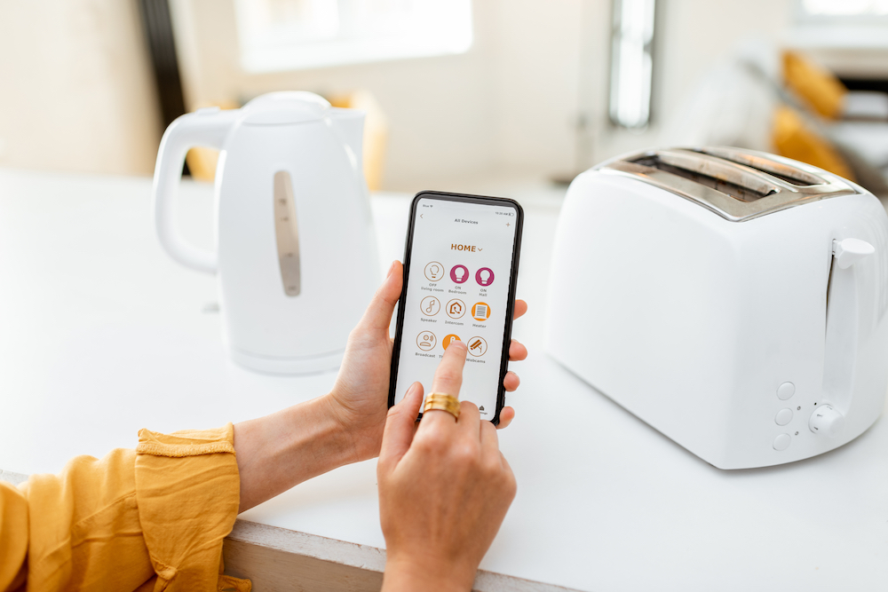 A woman using an app to control her toaster