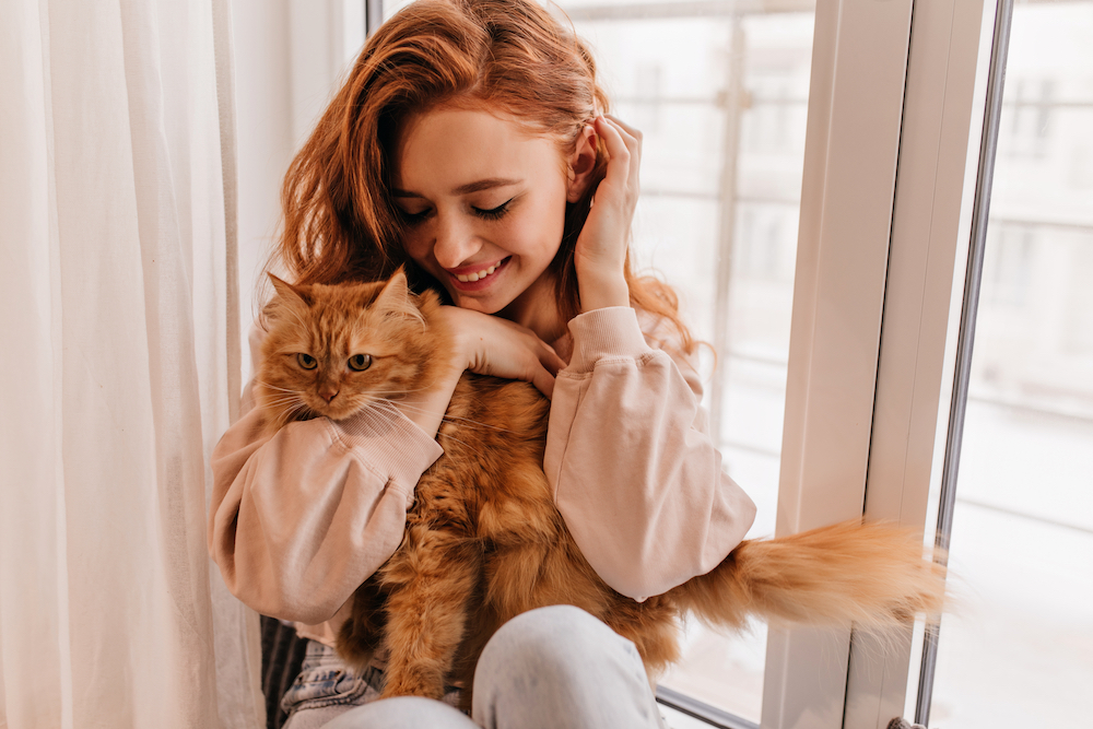 A woman and her cat in a downtown loft apartment