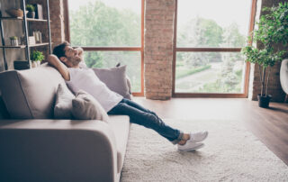 A happy young man hangs out in his loft apartment