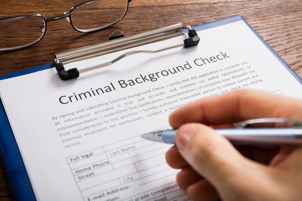 A person fills out a federal background check before renting an apartment