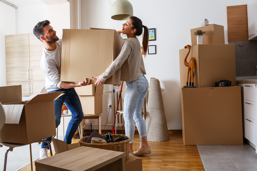 A young couple moves boxes into the apartments for rent in St. Joesph, MO