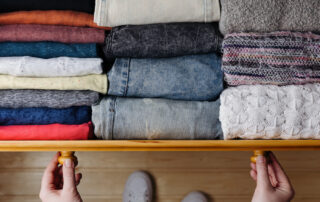 A man organizing his dresser drawers at the downtown apartments for rent