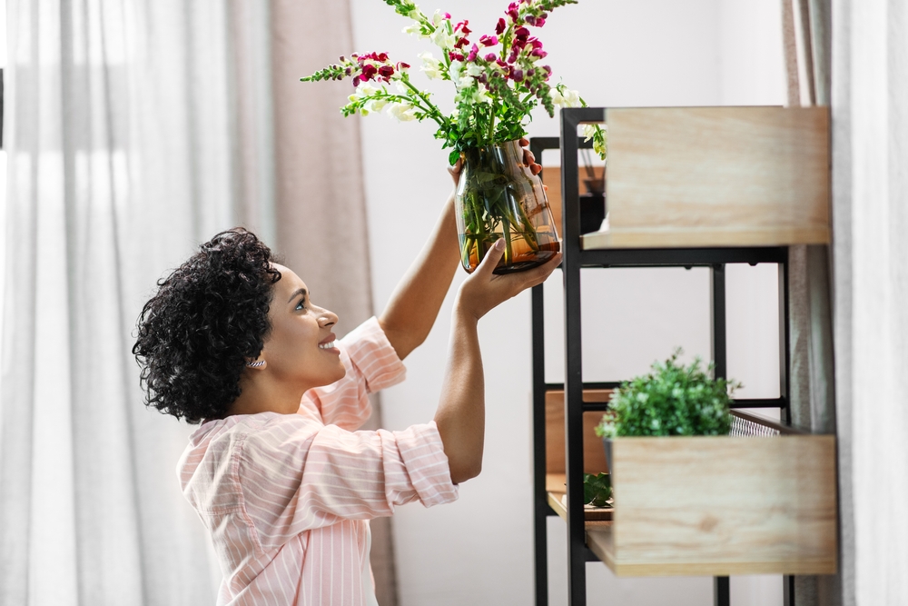Woman adding plant to her American Electric Loft Apartment
