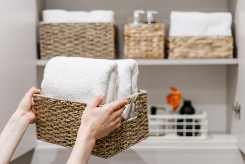 A young woman organizing her bathroom at her loft apartment