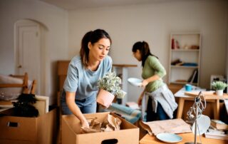 Two female roommates unpacking as they move in together at the apartments in Saint Joseph, MO