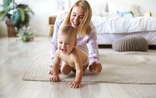 A mother and a baby play together a the loft apartments for rent in St. Joseph, MO