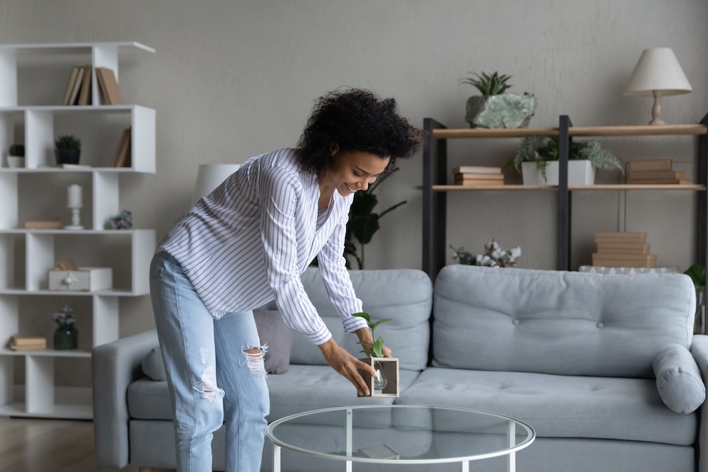 A woman decorating the coffee table in her loft apartment